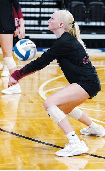Mya Swanson adds to her 56 digs and also had 17 kills to add to the Cards' first place finish at state. Photo by Larry Stokke.