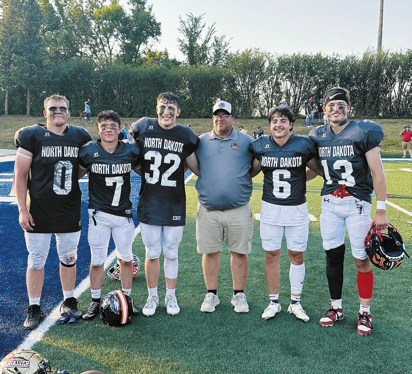 Here’s Coach Hartje with five players from Region 3 that played in the 9-man game (L-R): Kayden Rose and Logan Werner from Cavalier, Coke Henderson of North Prairie, Grant Cosley of North Border, and Ben Gudajtes from Midway-Minto.