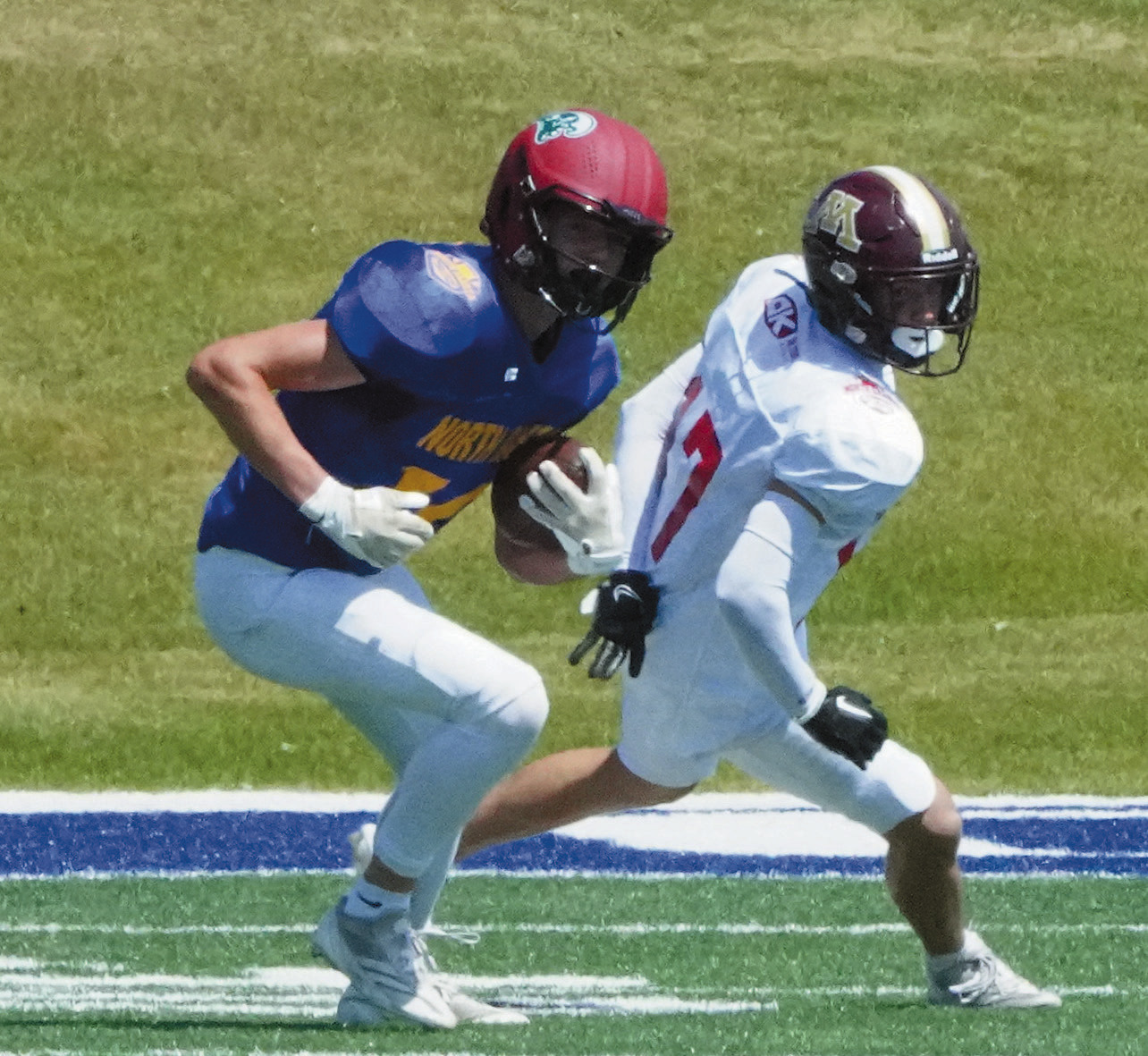 Cody Amble with an interception thrown by the West Team stopping a touchdown. Photo by Larry Stokke.