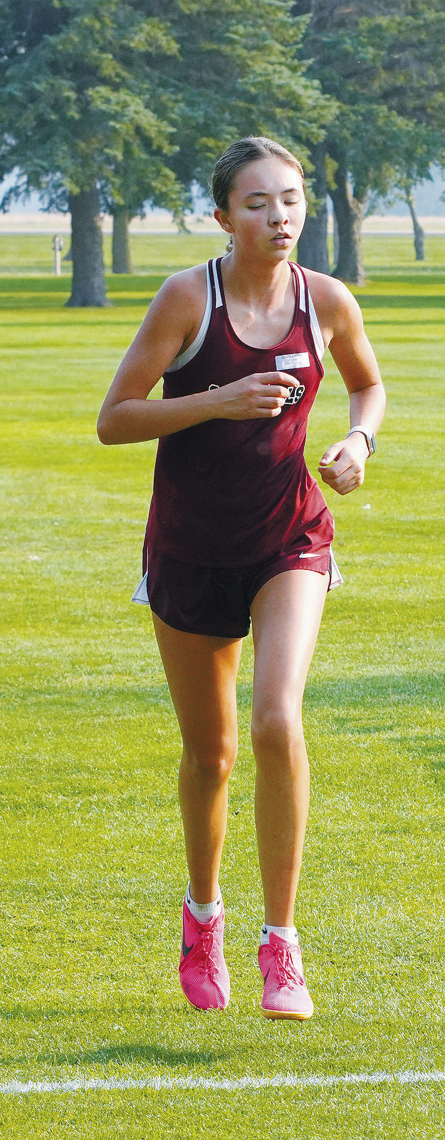 Olivia Lorenz crosses the finish line in 7th place at the Larimore Meet on Sept. 10. Photo by Larry Stokke.