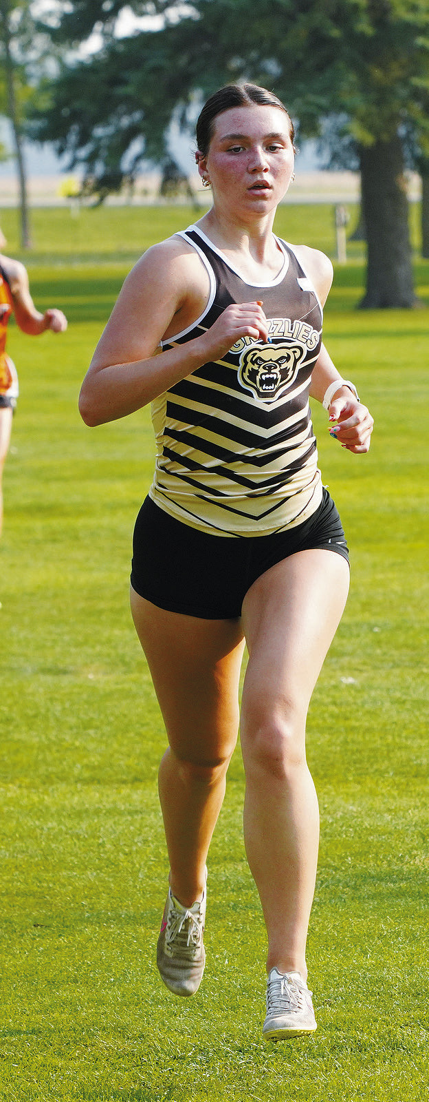 Delanie Denault ran to a 10th place finish in Larimore on Sept. 10. Photo by Larry Stokke.
