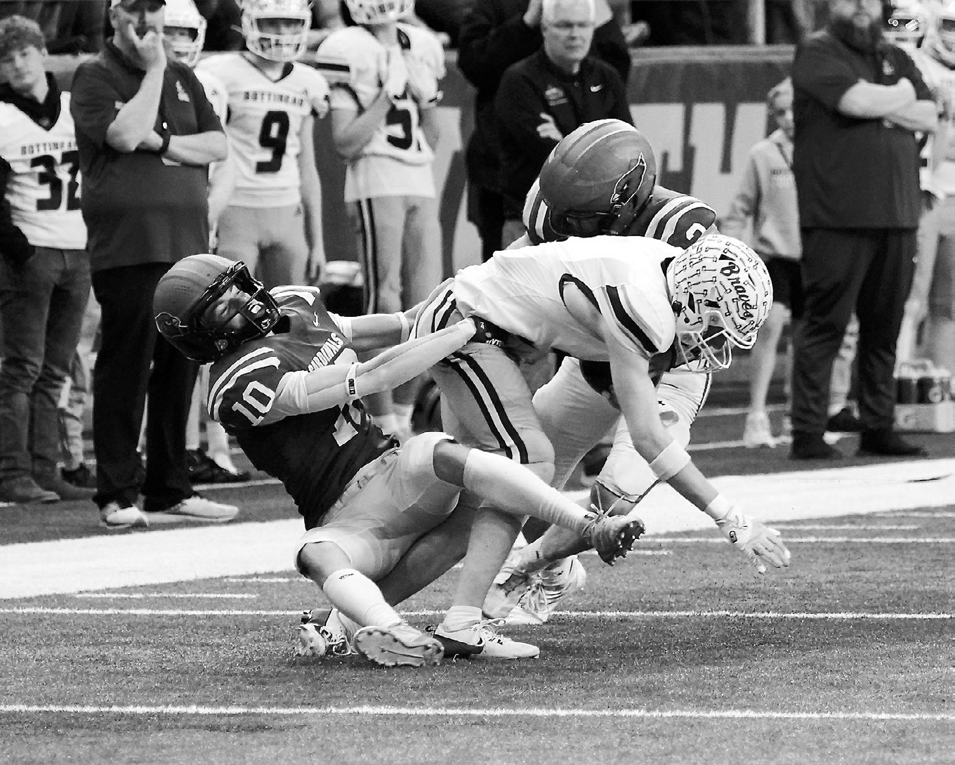 Maddux Stremick and Jax Johnson team up to stop a Bottineau ball carrier. Photo by Larry Stokke.