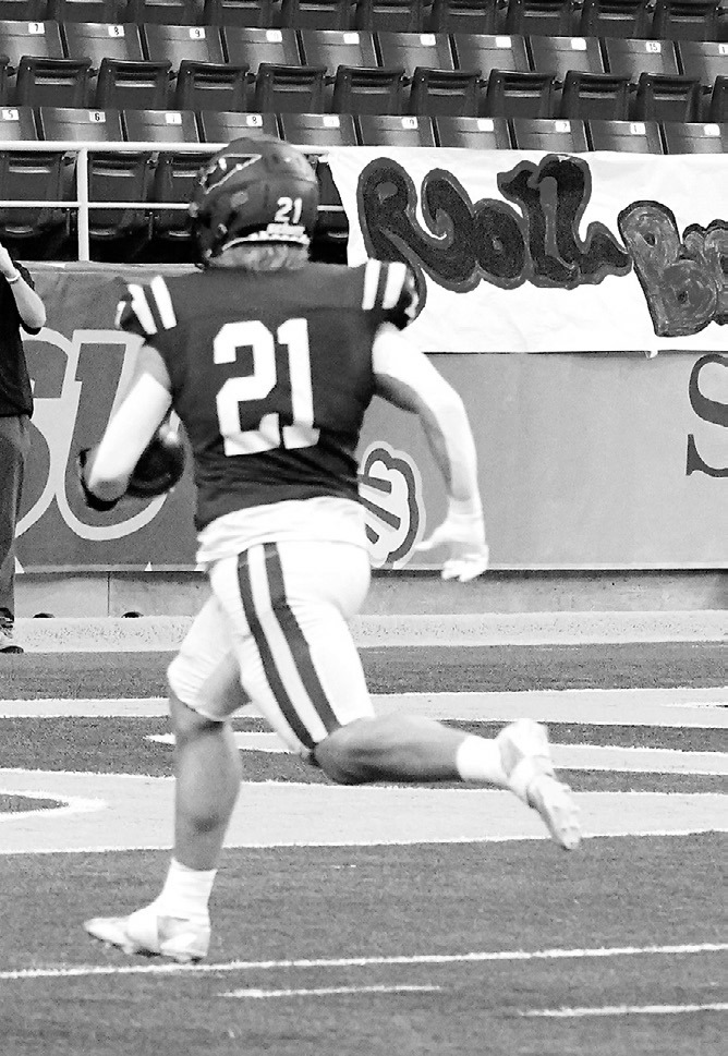 Theo Romfo runs in a touchdown for the Cardinals, helping them win the State Championship game. Photo by Larry Stokke.