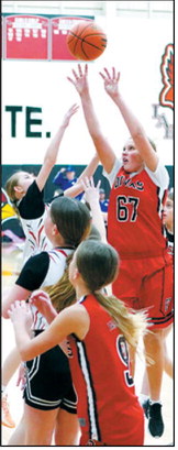 Blakely Medbery with a defenders hand in her face drains a basket. Photo by Larry Stokke