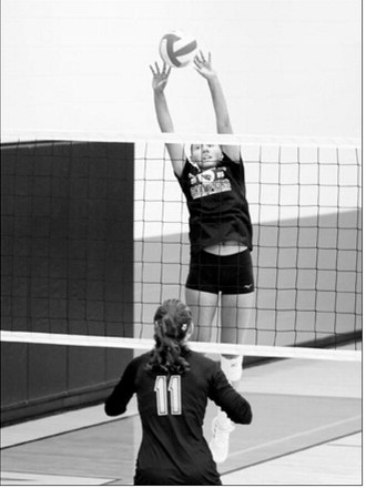 Langdon Area-Munich’s Aubrey Badding sends the ball over the net with a two-handed tip against Park River during a scrimmage Saturday, Aug. 22, in Thompson. Photo by Larry Stokke