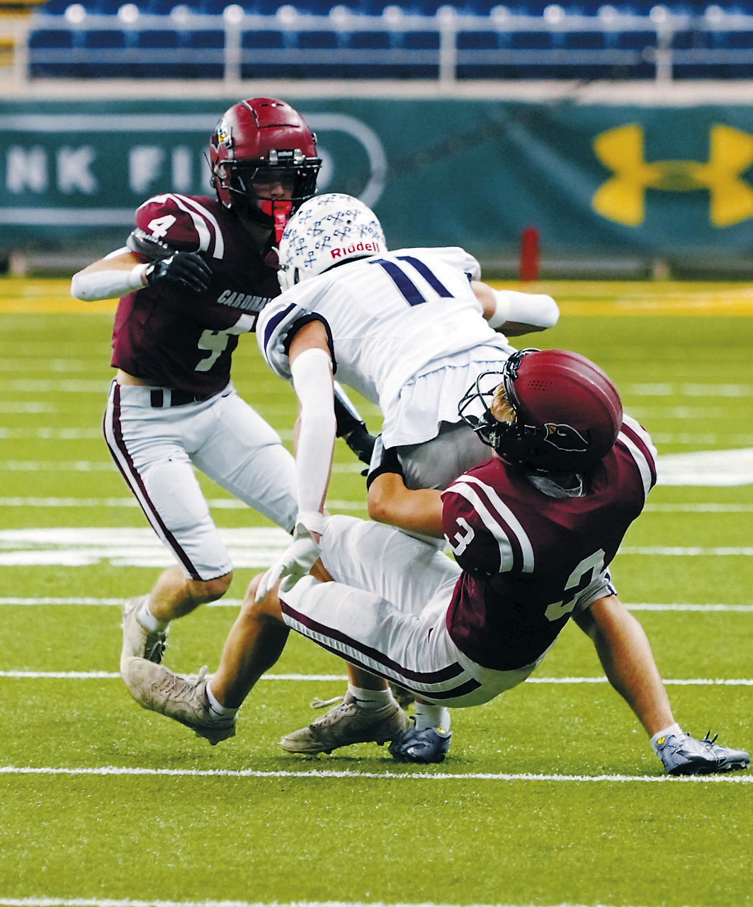 TJ Henderson tackles a Bottineau ball carrier during the State Championship game at the Fargodome. Photo by Larry Stokke