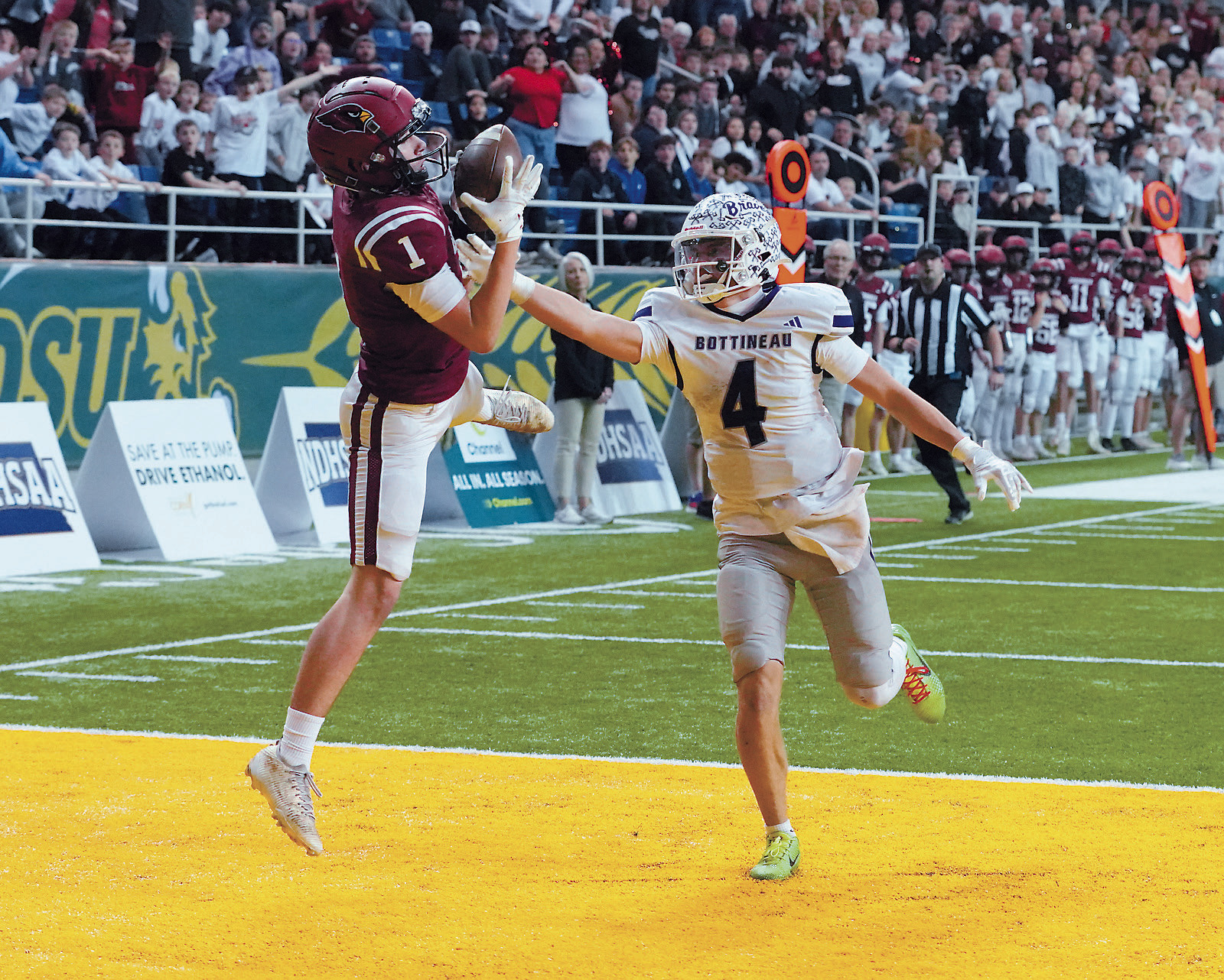 Eastyn Schaefer with one of his two touchdowns, helping the Cards claim the State Football Championship. Photo by Larry Stokke.