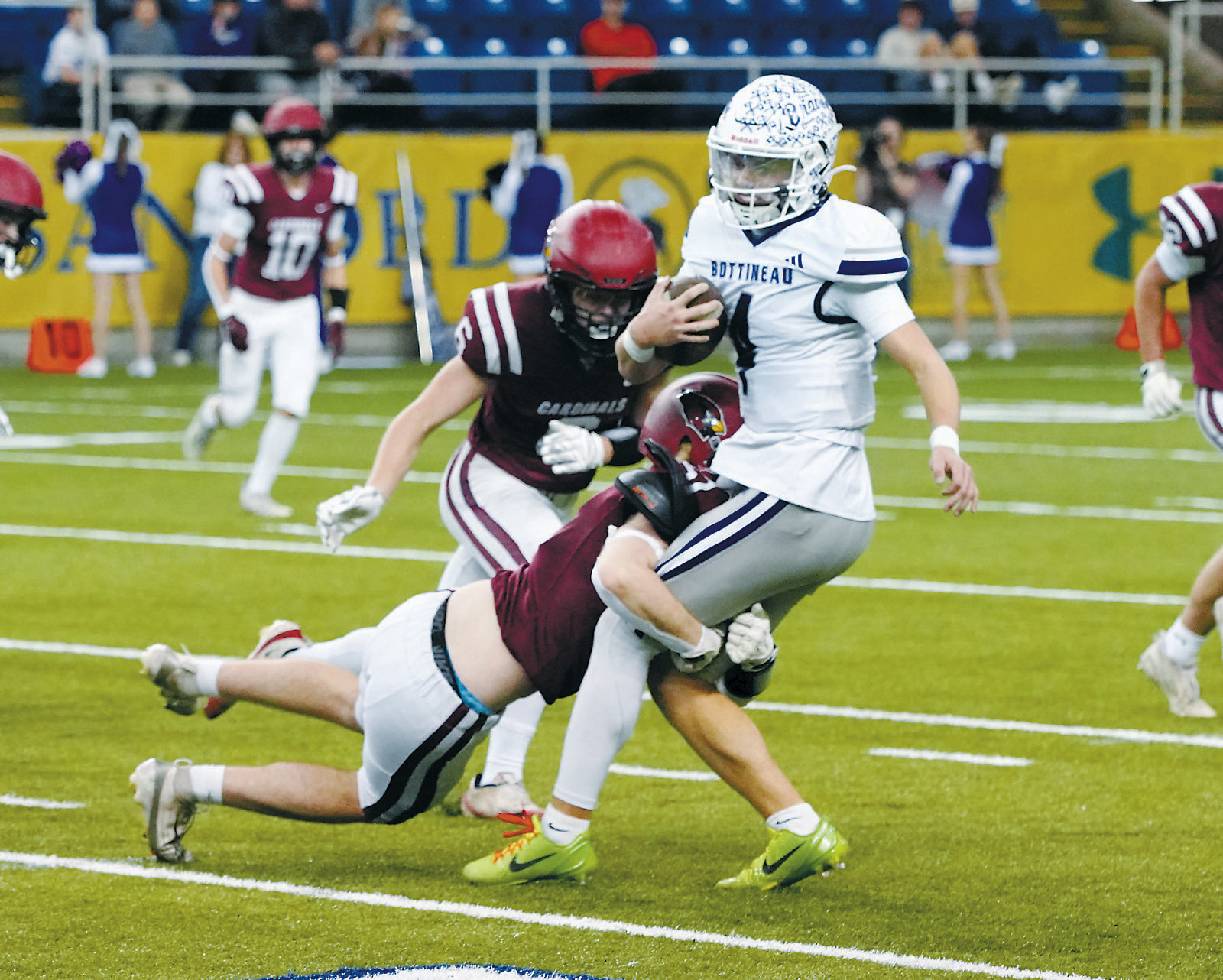 Keaton Ullyott makes a diving tackle on the Bottineau quarterback. Photo by Larry Stokke.