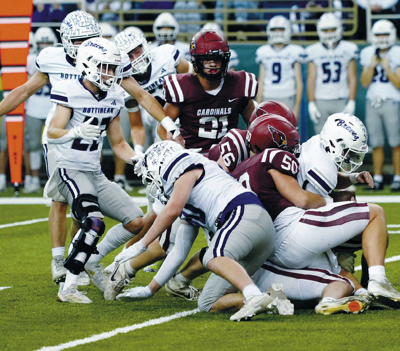 Landon Schneider and Devin Hakanson wrap up a Bottineau player for a turnover in downs in the Fargodome last week. Photo by Larry Stokke.