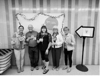 Pictured are election workers for the polling site: Koree Hoffman, clerk; Terry Jacobson, judge; Kari Phillips, inspector; Holly Fetsch, clerk; and Linda Harder, judge posing in front of the election day photo booth, which was set up for voters during Tuesday’s primary election. Photo by Lisa Gellner