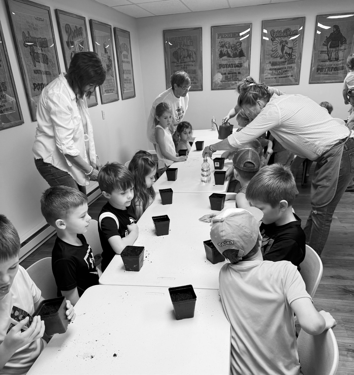 Story Hour attendees working on planting their pumpkins.