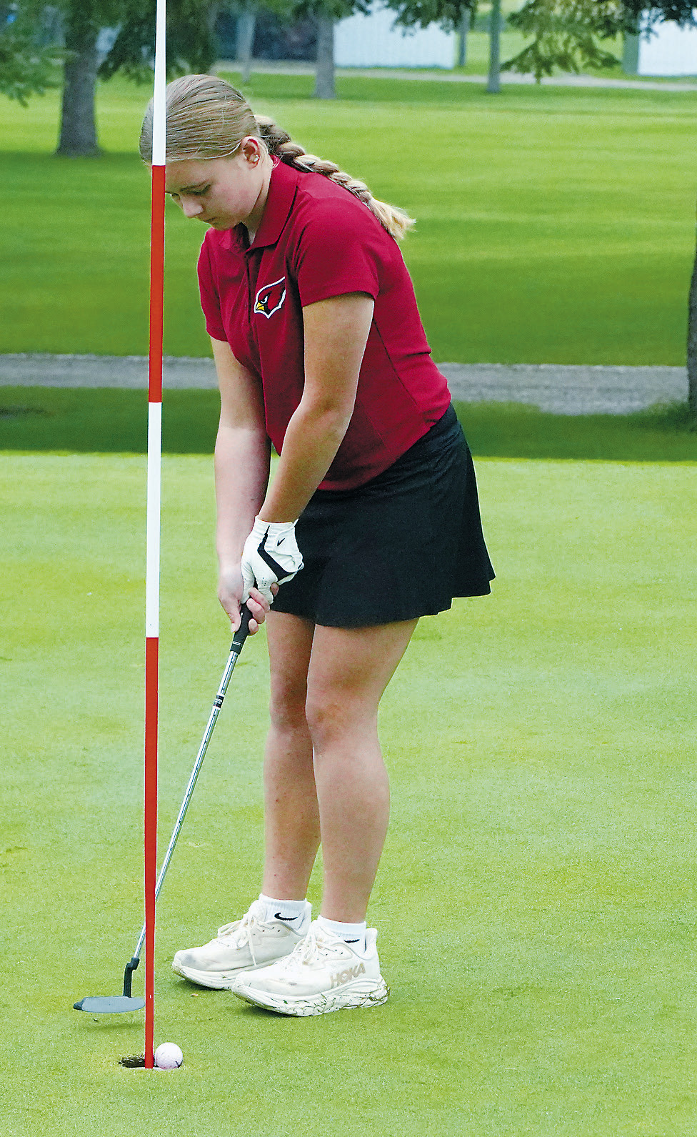 Harper Jacobson sinks a putt at the first meet of the year in Langdon. Photo by Larry Stokke.