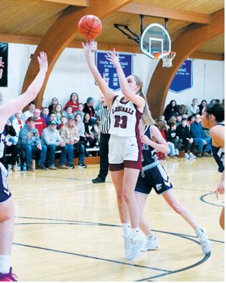 Hallie Overby sends one through the net in the Lady Cards win over the Cougars. Photo by Larry Stokke