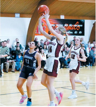 Hilary Haaven drops in a 2-point shot and finished with 11 points for the game. Photo by Larry Stokke