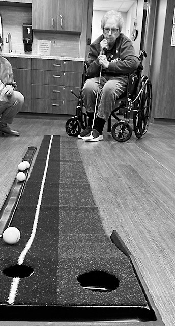 Darlene B. watching to see if she sinks her ball.