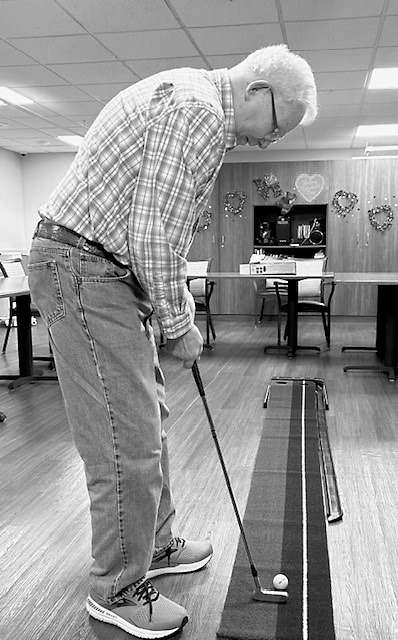 Dale taking his swing at golf.