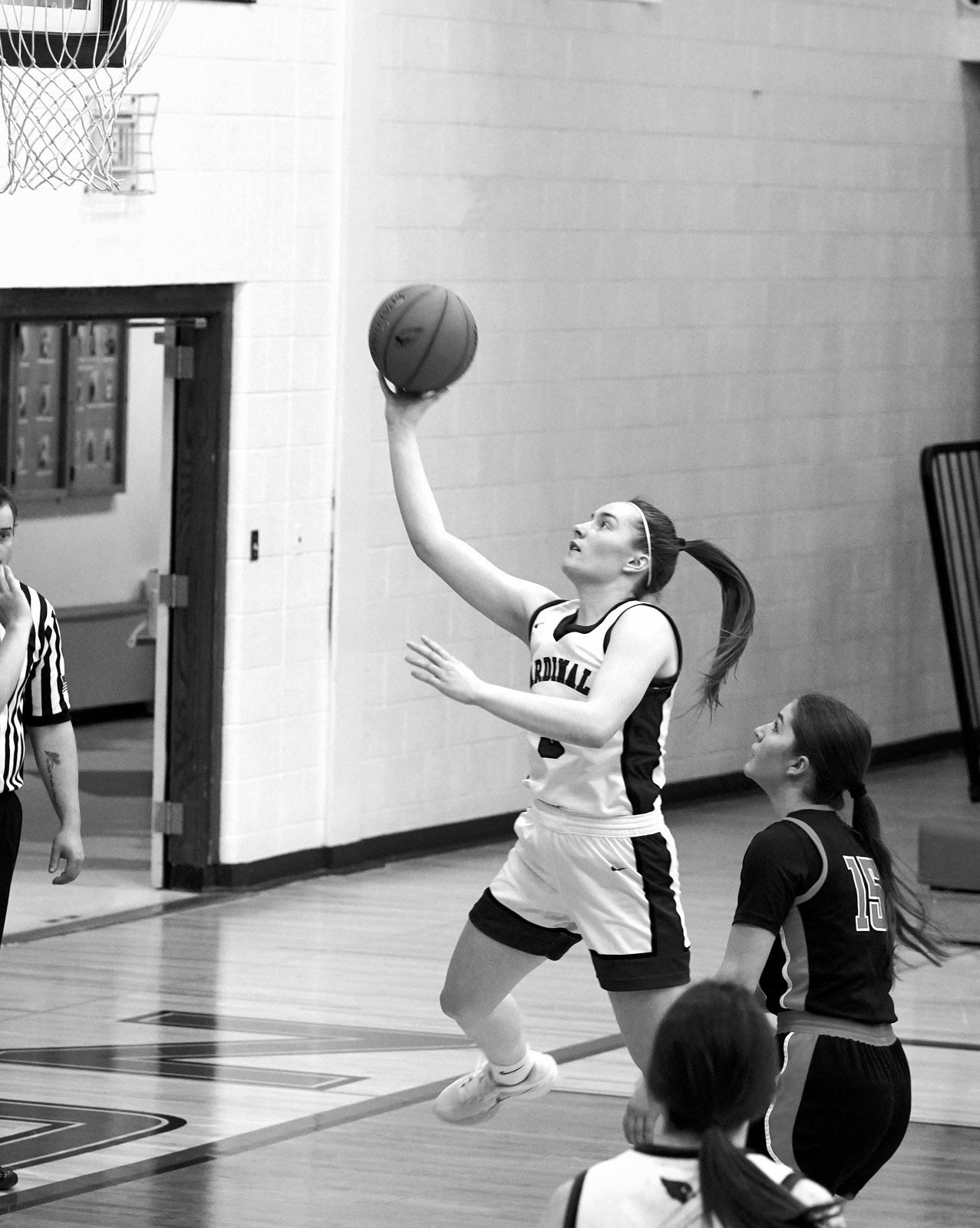 Meredith Romfo drops in a right-handed layup in the Cards game against the Cavalier Tornadoes at home on Feb. 3. Photo by Larry Stokke.