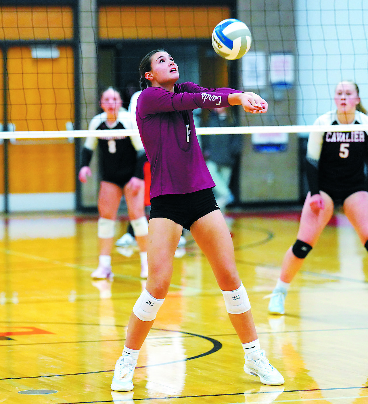 Taya Feist passes the ball to a teammate in the Cards' win over Cavalier. Photo by Larry Stokke.