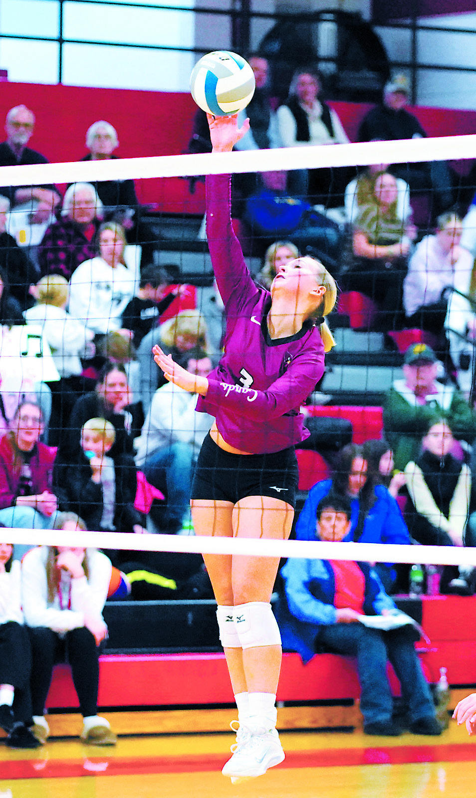 Emma Hall with a kill against the Tornadoes in the opening round of the Regional 2B Tournament. Photo by Larry Stokke.