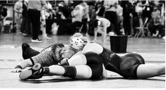 Charlotte Crowston, shown here pinning her opponent, placed 7th for the tournament in Fargo on Jan. 3. Photo by Larry Stokke.