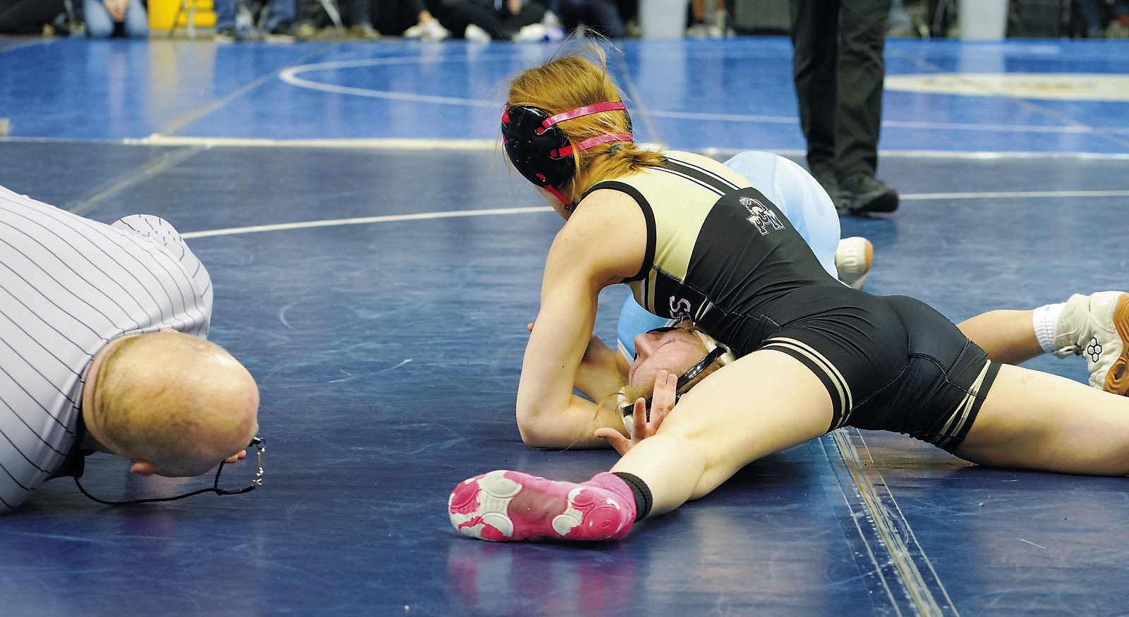 Dannika Bennett pins her girl on her way to finish in 6th place at state. Photo by Larry Stokke.