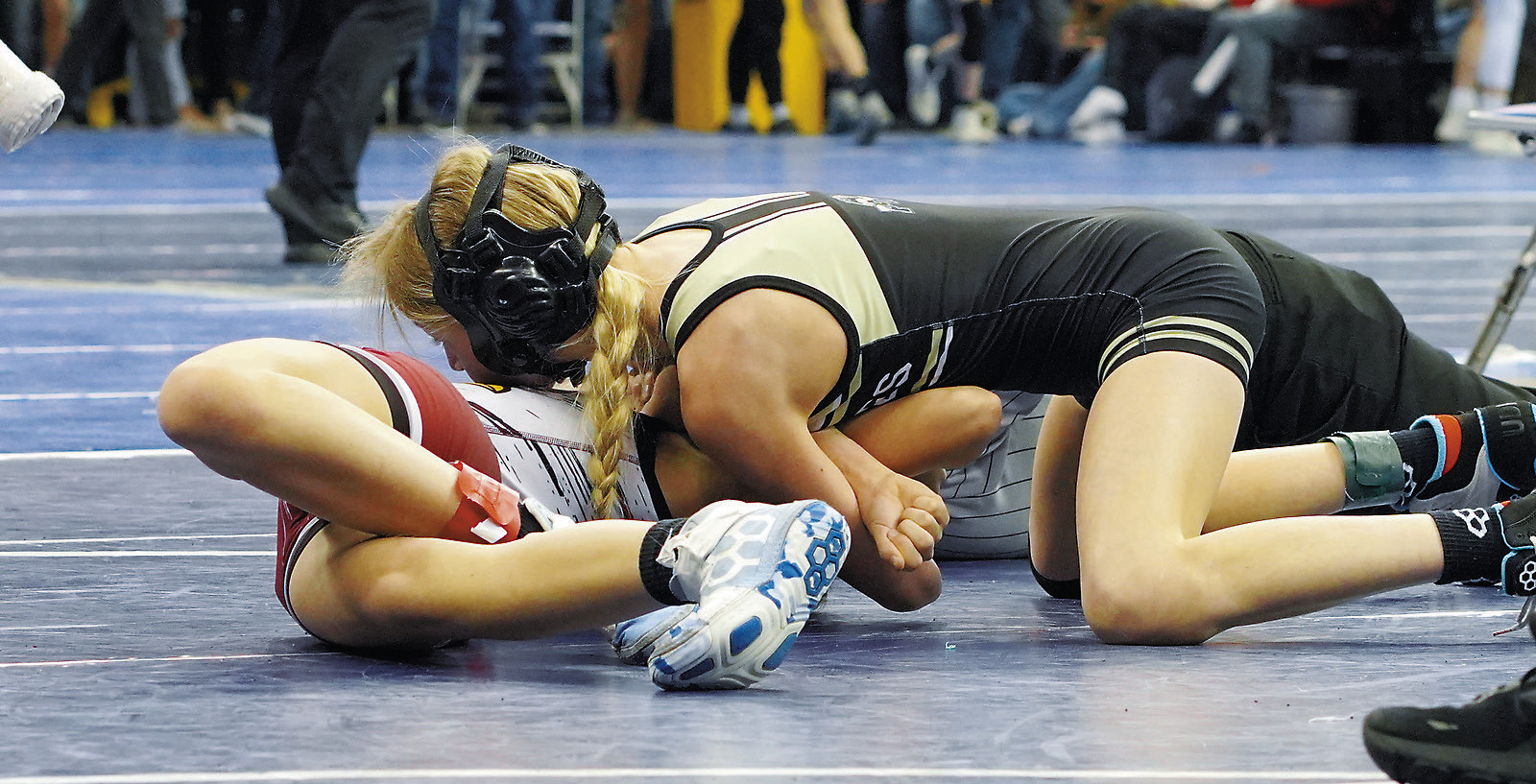 Maci Puppe pins her girls in the 106 lbs. weight class at state. Photo by Larry Stokke.