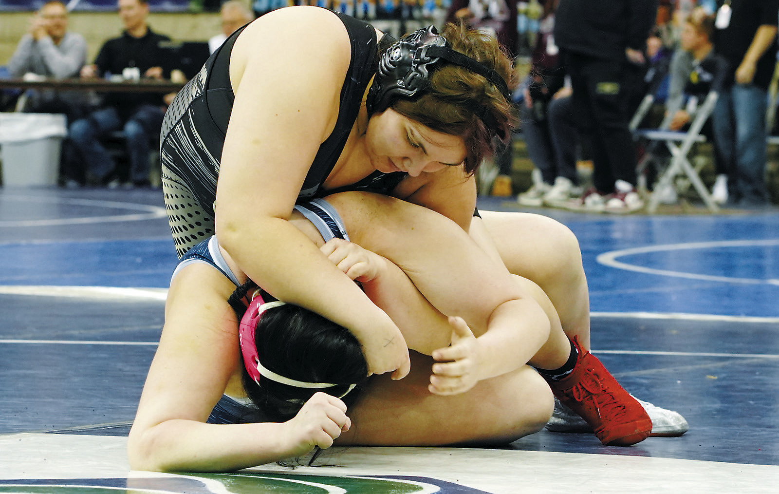 Jaelyn Forrey ties up her opponent and gets the pin on her way to a 7th place finish at state. Photo by Larry Stokke.