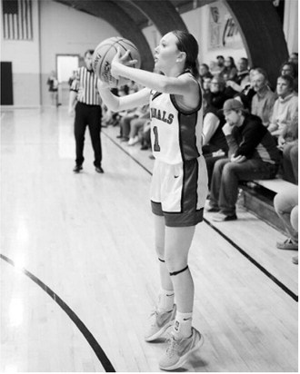Ary Schaefer drops in a 3-point basket in Munich on Jan. 12 against St. John. Photo by Larry Stokke.