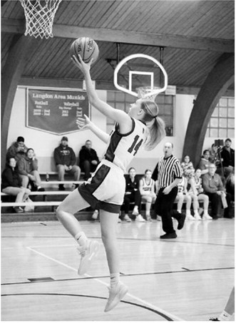 Hilary Haaven lays in a left-handed layup against the Woodchucks. Photo by Larry Stokke.