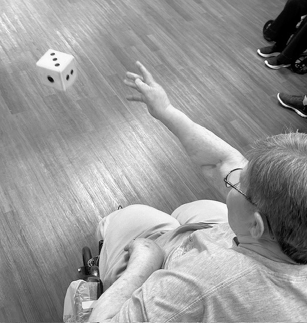 Anna Mae throwing dice in the PNC Olympics.
