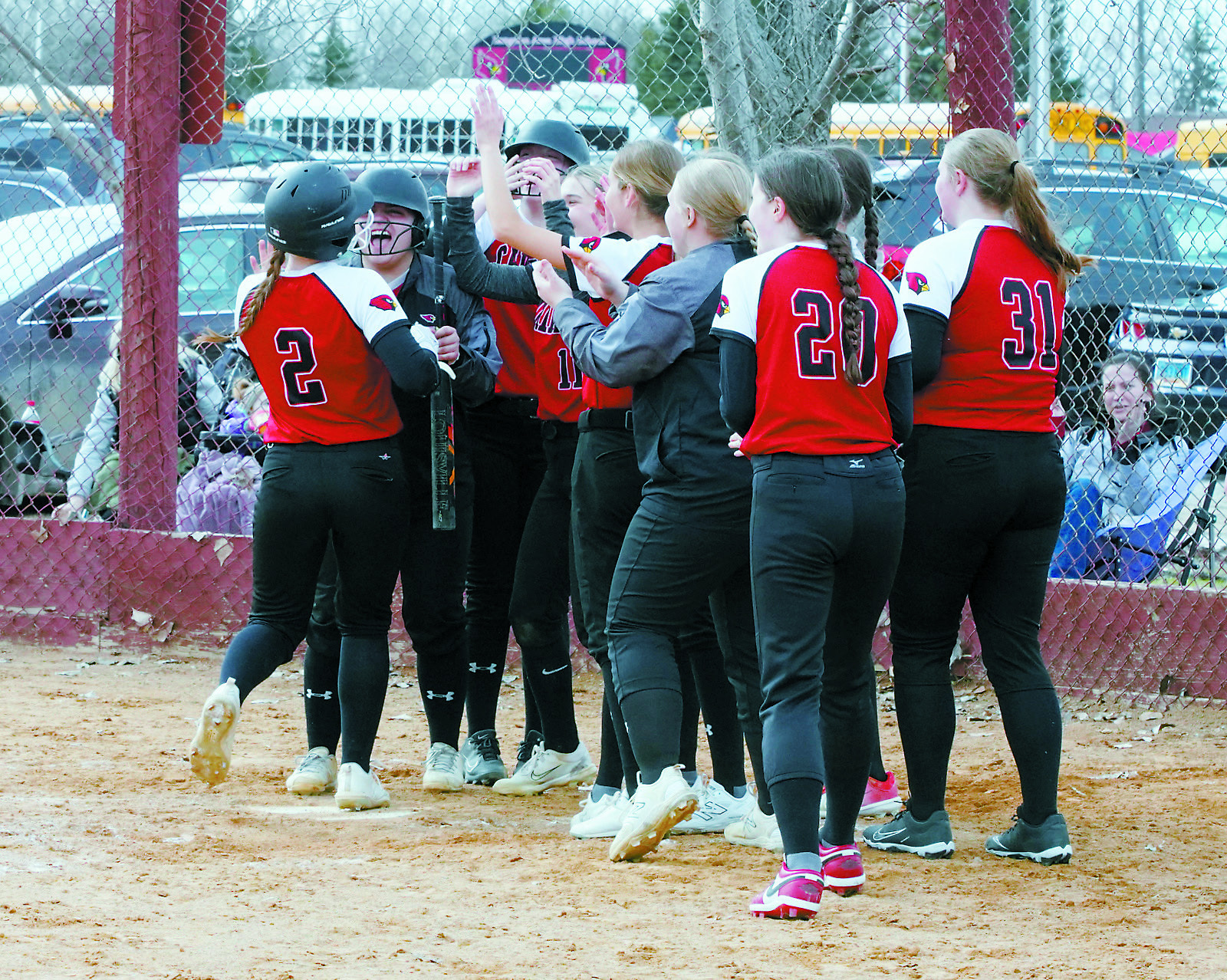 The Lady Cards celebrate Meredith's homerun she sent over the fence against Larimore. Photo by Larry Stokke.