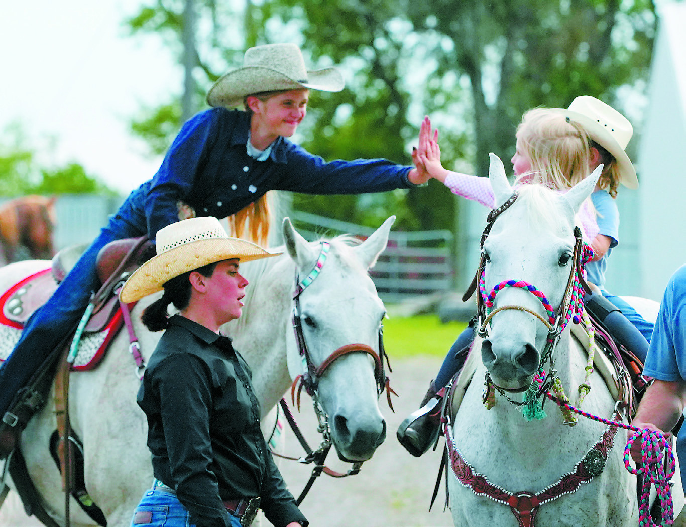 Equestrians cheering each other on at the 4H Horse Show at the Hamilton Fair. Photo by Larry Stokke.