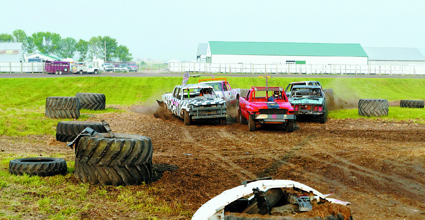 Fans in the stands were at the edge of their seats for the Redneck Pick-Up Truck Races. Photo by Larry Stokke.