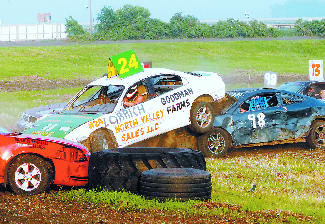 #98 collides with #24 during the Bush Car Races. Photo by Larry Stokke.