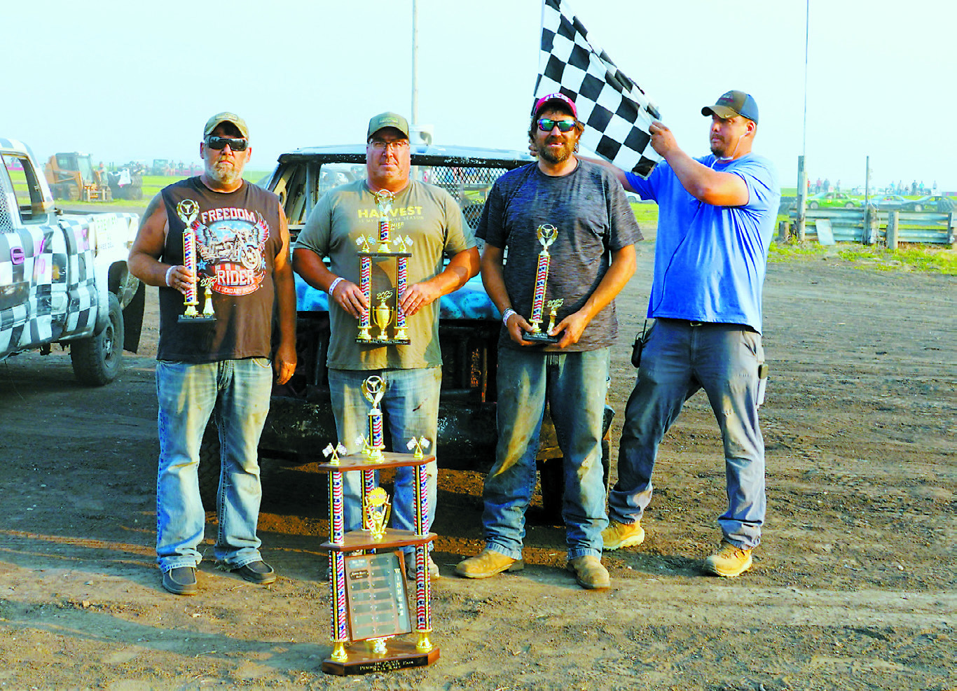 Redneck Pick-Up Race champions (L-R) 2nd place- Jon Erickson, 1st place- Bill Timm, and 3rd place- Kevin Berg, and organizer Mark Halverson. Photo by Larry Stokke.