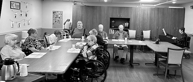 Residents participate in a sing along with a live pianist.