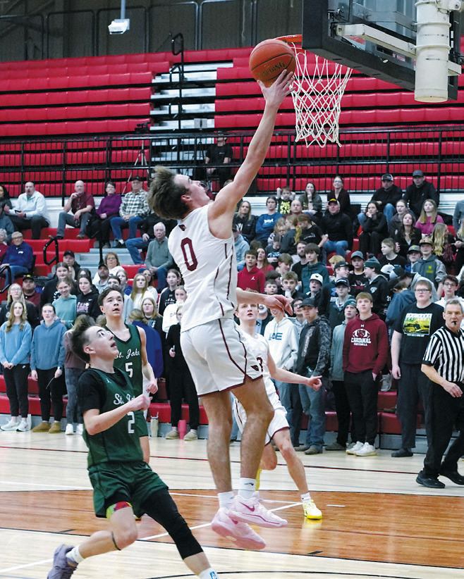 Jayden Lee on a fast break rolls in a basket. Photo by Larry Stokke.