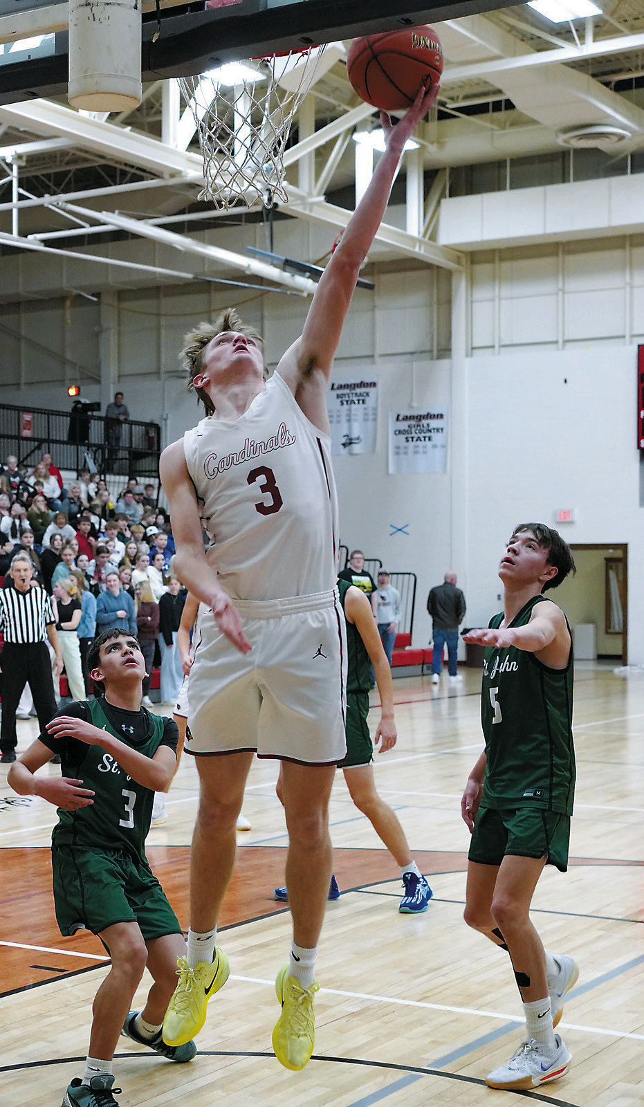 Player of the Game Cody Amble stretches out and lays in 2 points. He was also perfect from the free throw line to finish the game with 20 points. Photo by Larry Stokke.