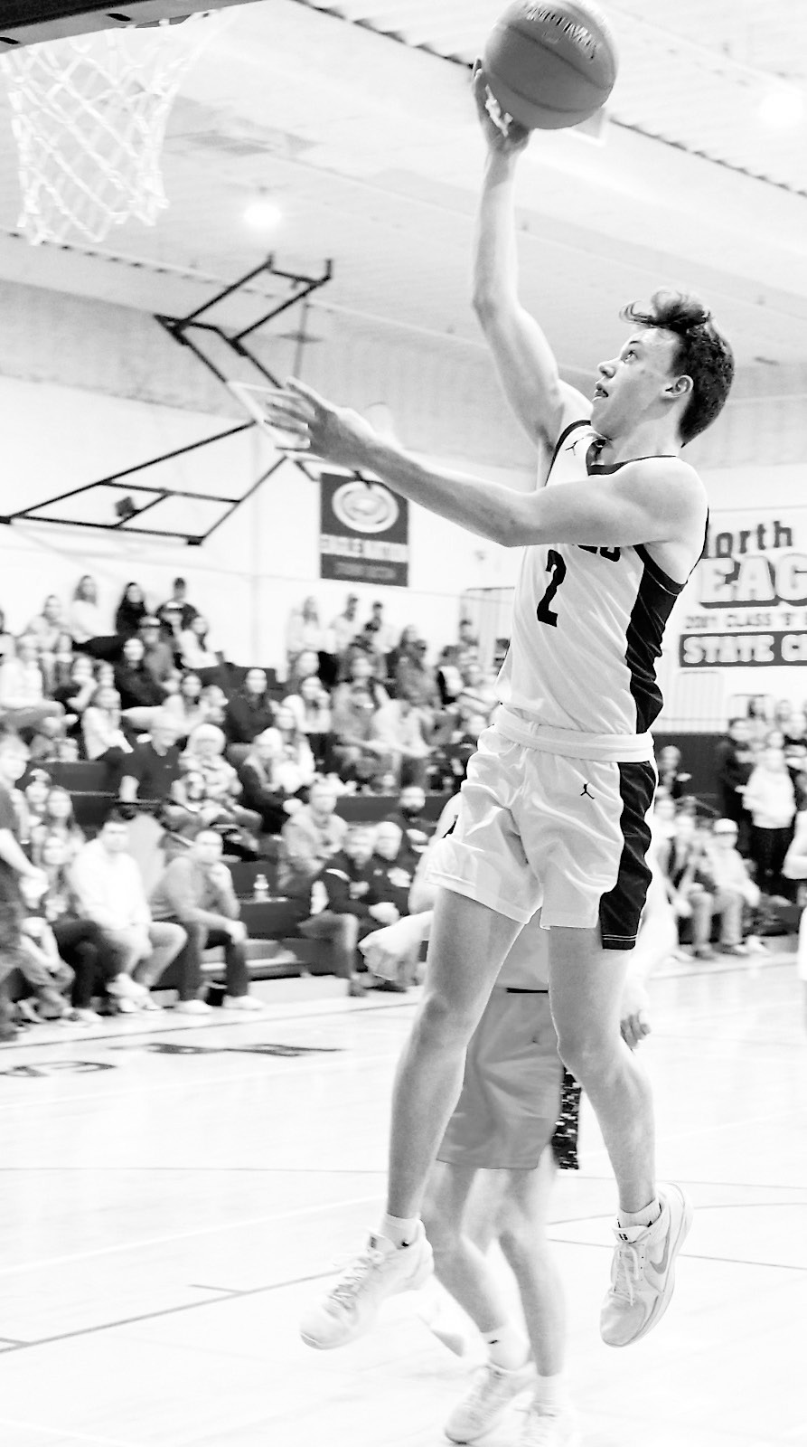 Kaden Moore lays in a basket to finish the win over the Tornadoes with 18 points. Photo by Larry Stokke.