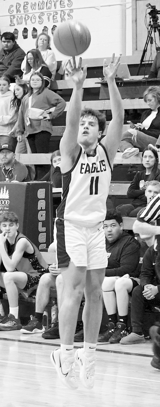 Grant Cosley drops in a 3-point basket in Walhalla on Jan. 27 with a full house when the Eagles defeated the Tornadoes. Photo by Larry Stokke.
