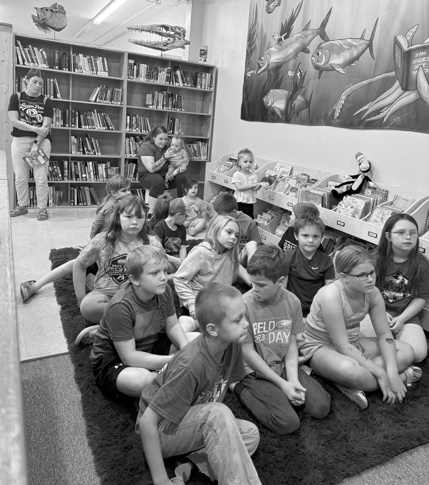 Story Hour attendees listening to their weekly book read by Mary Mostad.