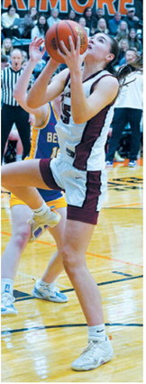 Taya Feist eyes the basket and adds two points to the Cards score. Photo by Larry Stokke