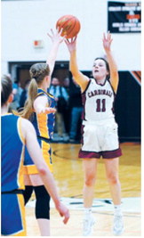Erika Bakke puts up a shot over a Benson County defender. Photo by Larry Stokke