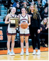 Cardinals Hilary Haaven, Erika Bakke and Aubrey Badding pose with the second place plaque and game ball. Photo by Larry Stokke