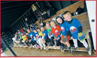 T-Ball players gather in the dugout during Buddy Night. Submitted photo