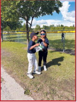 Two youngsters pause for a photo while watching the action at the ballpark. Submitted photo