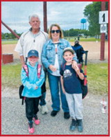 Marty and Sherry Pengilly pose with their grandchildren, Karsyn and Logan, before the youngsters' games in Langdon. The family was on hand to cheer them on from the sidelines. Submitted photo