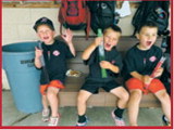 Young fans cool off with frozen treats in the dugout while taking a break from the action during a summer baseball game. Submitted photo