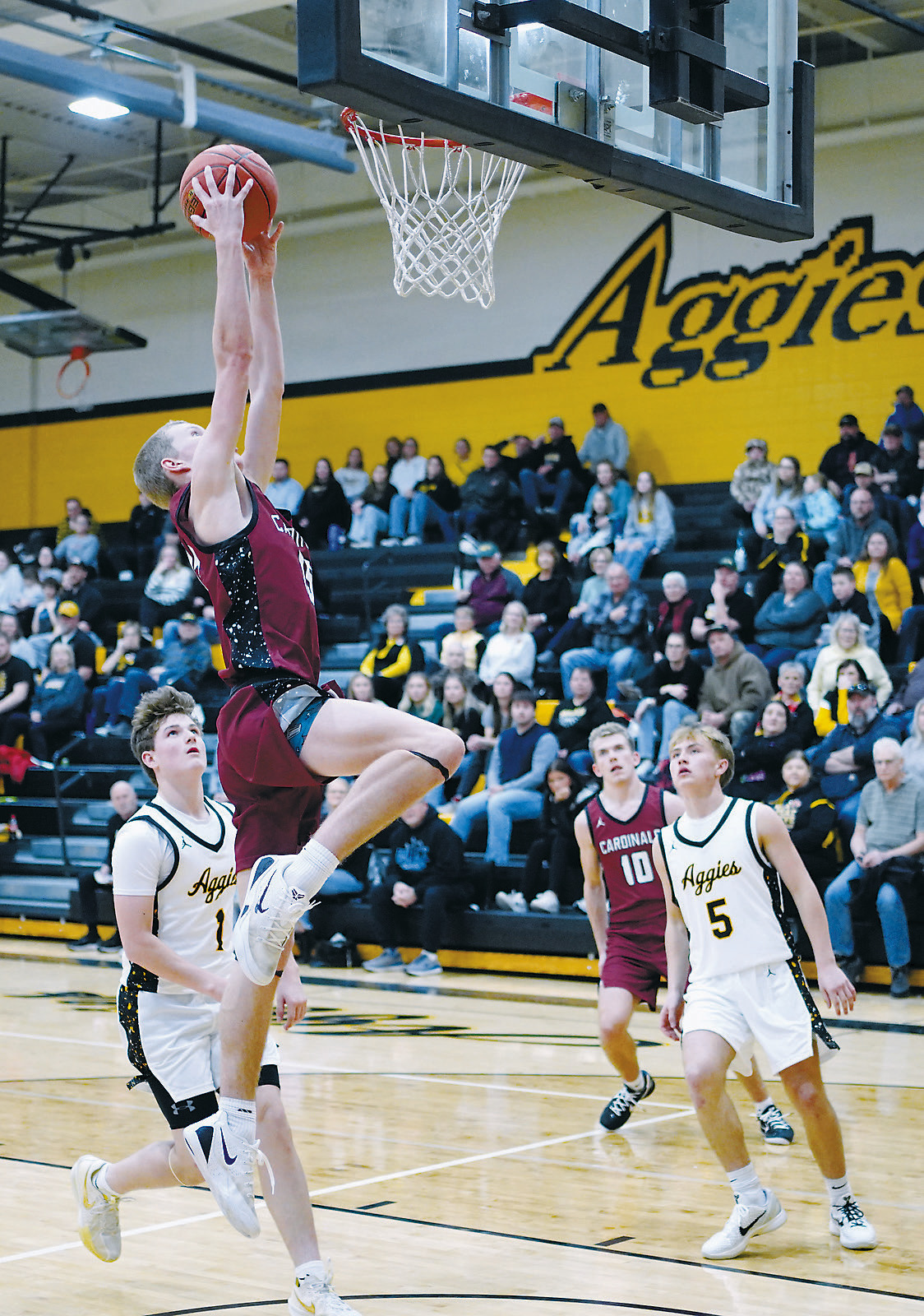 Caleb McDonald goes up and dunks the ball in the Cards' win over the Aggies. Photo by Larry Stokke.