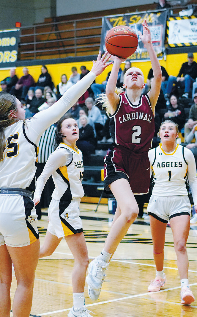 Mya Swanson drives into the lane and puts up a shot in the Lady Cards' win over the Aggies. Photo by Larry Stokke.